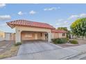 View of the home's front exterior featuring a terracotta tile roof and a covered carport area at 3625 Barcelona St, Las Vegas, NV 89121