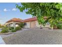 Charming home with a terracotta roof, landscaped front yard, and a small seating area near the entrance at 3625 Barcelona St, Las Vegas, NV 89121