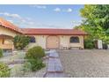 Charming home with terracotta tile roof featuring a landscaped front yard and stone walkway at 3625 Barcelona St, Las Vegas, NV 89121