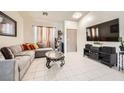 Comfortable living room with tile flooring, ample seating and a media center for relaxed entertainment at 3642 Winter Whitetail St, Las Vegas, NV 89122