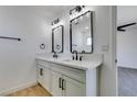 Bright bathroom featuring double sinks, white countertops, and modern fixtures at 3986 Belleville Ave, Las Vegas, NV 89121