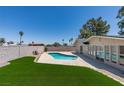 Backyard oasis showcasing a sparkling pool, lush turf, and privacy fencing at 3986 Belleville Ave, Las Vegas, NV 89121