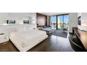 Bright main bedroom suite boasts a modern design, sleek furniture, and a panoramic city view from the balcony at 4381 W Flamingo Rd # 2220, Las Vegas, NV 89103