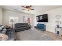 Cozy living room featuring a large TV, comfortable sofas, and access to the backyard patio at 4780 Lorenzo Way, Pahrump, NV 89061