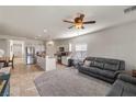 Open floor plan showcasing the living room adjacent to the kitchen with tile and carpet flooring at 4780 Lorenzo Way, Pahrump, NV 89061