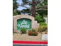 Community signage with lush landscaping, showcasing a welcoming neighborhood at 4805 S Torrey Pines Dr # 101, Las Vegas, NV 89103