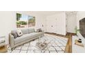 Bright living room with a large window, modern sofa, and stylish decor at 5078 Mountain Vista St, Las Vegas, NV 89120
