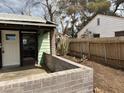 Covered patio with brick-wall surround and view of fenced yard at 524 5Th St, Boulder City, NV 89005