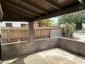 Outdoor patio with covered ceiling, brick siding, and fenced background at 524 5Th St, Boulder City, NV 89005