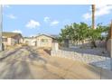Street view of single-story home featuring solar panels and desert landscaping at 5453 Yvonne Cir, Las Vegas, NV 89122