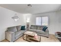 Cozy living room with two grey sofas, neutral carpet and plenty of natural light at 6735 W Charleston Blvd # 4, Las Vegas, NV 89146