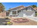 Well-maintained front yard with desert landscaping and charming exterior details at 6961 Ray Charles Ln, Las Vegas, NV 89119