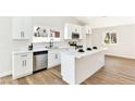 Bright kitchen showcasing a modern island and stainless steel appliances at 811 Spyglass Ln, Las Vegas, NV 89107