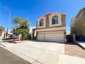 Attractive two-story home featuring a spacious driveway, a two-car garage, and tasteful landscaping for curb appeal at 8125 Rio De Janeiro Dr, Las Vegas, NV 89128