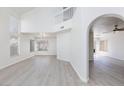 Bright living area with high ceilings, large windows, and light wood-look flooring at 92 Sea Holly Way, Henderson, NV 89074