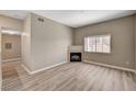 Spacious living room with a fireplace and modern wood-look floors at 9303 Gilcrease Ave # 2217, Las Vegas, NV 89149