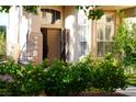 Inviting front entrance with an open door, decorative features, and manicured landscaping at 9440 Grenville Ave, Las Vegas, NV 89134