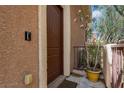 Welcoming front door with a charming potted plant, creating an inviting entrance at 9975 Sand Key St, Las Vegas, NV 89178