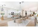 Open-concept dining room with a modern table and seamless flow to the kitchen at 10017 Snow Crest Pl, Las Vegas, NV 89134