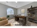 The staged home office offers ample natural light and an efficient work space at 10518 Santerno St, Las Vegas, NV 89141