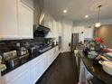 Modern kitchen featuring white cabinets, granite countertops, and stainless steel appliances at 119 Colantonio Ct, Las Vegas, NV 89138
