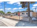 Quaint single-story home with xeriscaping and a bold red front door, nestled in a sunny neighborhood at 1417 Dogwood Ave, North Las Vegas, NV 89030