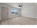 Bright living room with laminate floors, white brick walls, and an abundance of natural light at 1417 Dogwood Ave, North Las Vegas, NV 89030