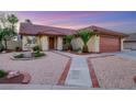 Beautiful single-story home with desert landscaping, a two-car garage, and a tile roof at 160 Coastal Pier Ct, Henderson, NV 89002