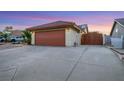 Charming single-story home featuring a two-car garage and an enclosed gate to the backyard at 160 Coastal Pier Ct, Henderson, NV 89002