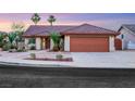 Charming single-story home featuring a desert landscape, a two-car garage, and a tile roof at 160 Coastal Pier Ct, Henderson, NV 89002