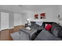 Comfortable living room features a plush grey sofa, hardwood floors and a minimalist decor at 2451 N Rainbow Blvd # 2043, Las Vegas, NV 89108