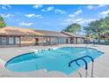 A well maintained residential pool with a clear blue water under a partly cloudy sky at 2451 N Rainbow Blvd # 2043, Las Vegas, NV 89108