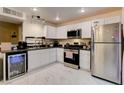 Modern kitchen featuring white cabinetry, stainless steel appliances, and a beverage fridge at 3322 Dragon Fly St, North Las Vegas, NV 89032
