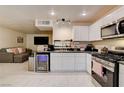 Open-concept kitchen with sleek appliances, ample counter space, and a view into the cozy living area at 3322 Dragon Fly St, North Las Vegas, NV 89032