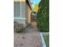 This house features a side yard, neutral exterior, with a metal gate separating the front and back at 3416 Mountain Park St, Las Vegas, NV 89129