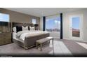 Spacious main bedroom with large windows showcasing mountain views and ensuite bathroom access at 390 Arizona St # Lot 9, Boulder City, NV 89005