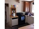Modest kitchen featuring black oven/stovetop and wooden shelves at 4931 Nevada Ave, Las Vegas, NV 89104