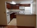 Cozy kitchen featuring breakfast bar, and essential appliances at 5383 Indian River Dr # 327, Las Vegas, NV 89103
