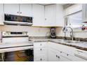 Kitchen features stainless steel appliances, white cabinets, and a double sink at 5706 W Lake Mead Blvd, Las Vegas, NV 89108
