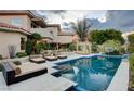 Inviting backyard boasts a sparkling pool, cabana, and multiple lounge areas for relaxing and entertaining at 60 Innisbrook Ave, Las Vegas, NV 89113
