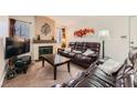 Comfortable living room featuring a cozy fireplace and a large, leather sofa set at 605 Devonhall St # 201, Las Vegas, NV 89145