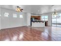 Open-concept living area with hardwood floors, a ceiling fan, and natural light at 6325 Orions Tool St, North Las Vegas, NV 89031