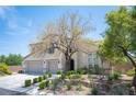 Charming two-story home with stucco exterior, two-car garage, and mature landscaping at 7538 Mustang St, Las Vegas, NV 89131