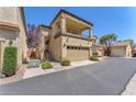 Exterior view showcasing the two-story home with a two-car garage and stairway at 7852 Running Doe Ct, Las Vegas, NV 89149