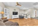 Inviting living room with wood floors, large windows, and neutral decor at 7852 Running Doe Ct, Las Vegas, NV 89149