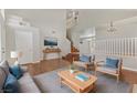 Bright living room with modern furniture, hardwood floors, and neutral tones, offering a welcoming and stylish atmosphere at 7973 Macklin St, Las Vegas, NV 89129