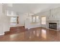 Spacious living room features hardwood floors, fireplace, and neutral paint, creating a cozy and inviting space at 7973 Macklin St, Las Vegas, NV 89129