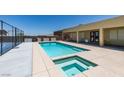 A beautiful in-ground pool and hot tub with an adjacent sport court are perfect for relaxing and entertaining at 7998 W Ford Ave, Las Vegas, NV 89113