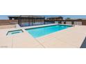 A dazzling in-ground pool and spa provide an oasis, with sport court in the background, for outdoor enjoyment at 7998 W Ford Ave, Las Vegas, NV 89113