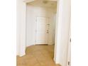 This bright entryway features tile floors, white walls and a white front door, offering a welcoming atmosphere at 8550 Bright Bush St, Las Vegas, NV 89131